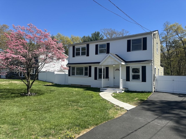 300 Prairie Dr, North Babylon, NY 11703 - colonial house with a gate, a front lawn, and fence