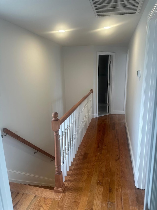 300 Prairie Dr, North Babylon, NY 11703 - hall with baseboards, an upstairs landing, wood finished floors, and visible vents