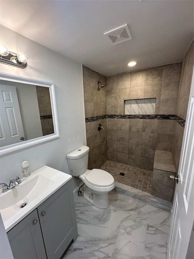 300 Prairie Dr, North Babylon, NY 11703 - full bathroom with visible vents, vanity, toilet, recessed lighting, and a tile shower