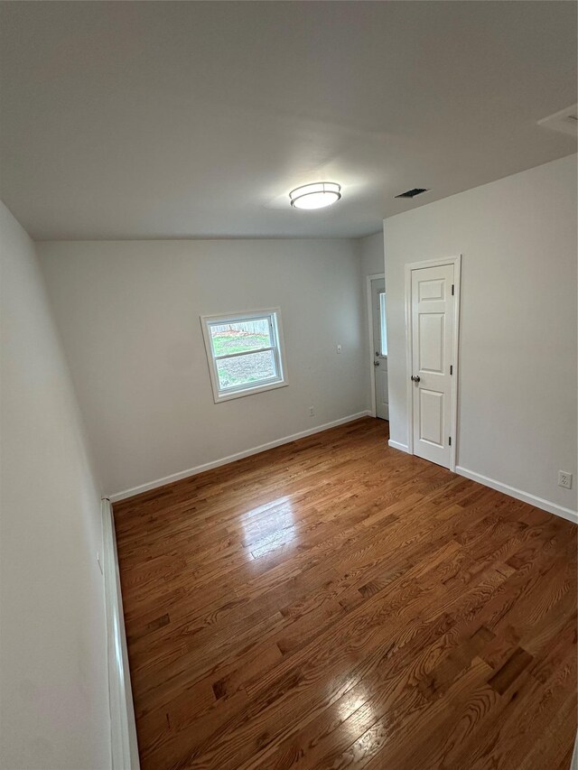 300 Prairie Dr, North Babylon, NY 11703 - spare room with baseboards, wood finished floors, and visible vents