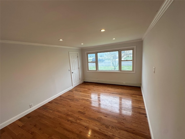300 Prairie Dr, North Babylon, NY 11703 - unfurnished room with crown molding, wood finished floors, baseboards, baseboard heating, and recessed lighting