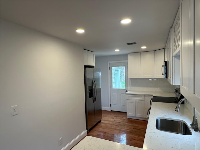 300 Prairie Dr, North Babylon, NY 11703 - kitchen with white cabinets, appliances with stainless steel finishes, a sink, recessed lighting, and dark wood-style floors
