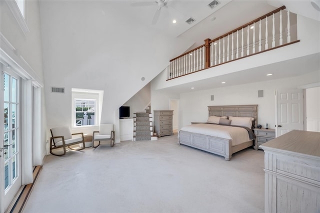 bedroom featuring high vaulted ceiling, visible vents, and light carpet