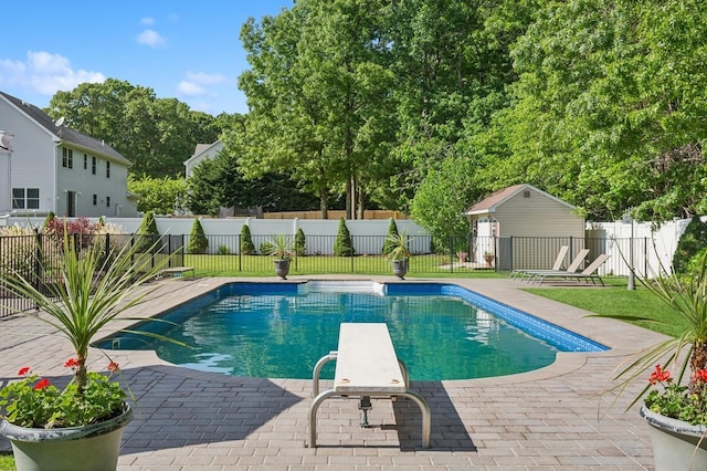 view of pool with fence, a diving board, a patio, and a fenced in pool