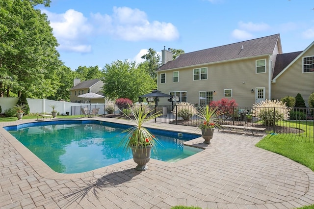 view of swimming pool with a gazebo, a fenced backyard, a fenced in pool, and a patio area