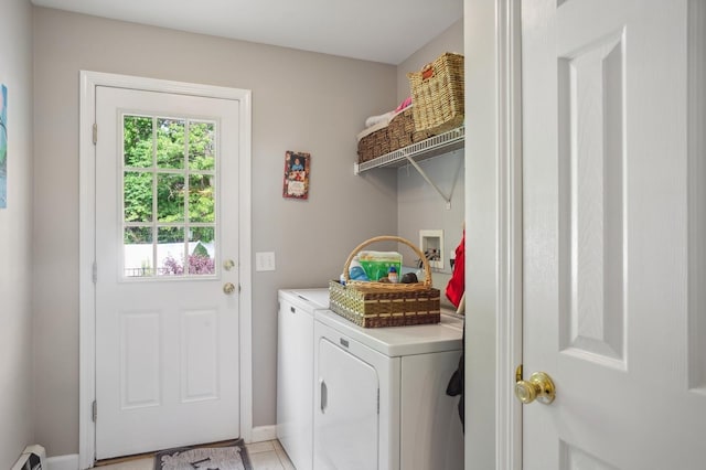 clothes washing area with baseboards, a baseboard heating unit, washing machine and clothes dryer, and laundry area