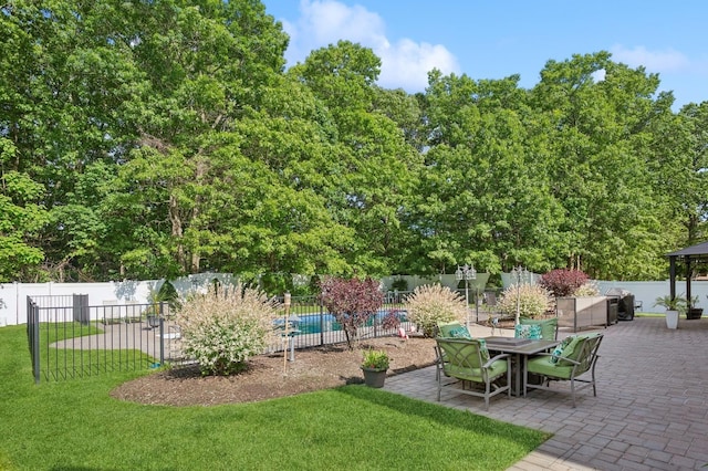 exterior space with a lawn, a patio, and fence