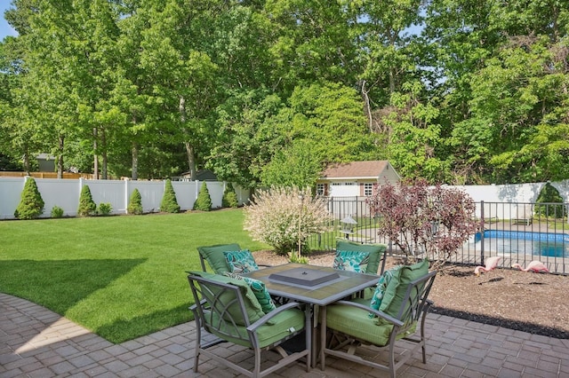 view of patio / terrace featuring a fenced backyard, outdoor dining area, and a fenced in pool