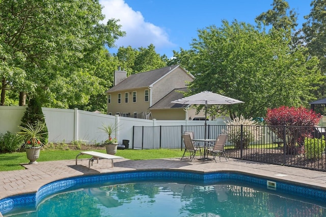 view of swimming pool with a fenced backyard, a fenced in pool, and a patio area