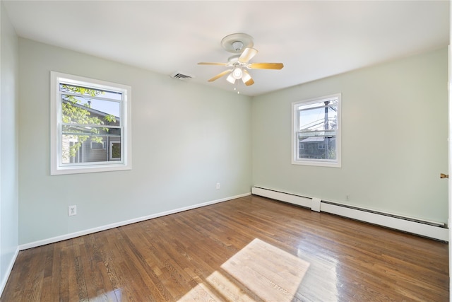 empty room with wood finished floors, a baseboard radiator, ceiling fan, and visible vents