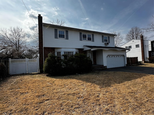 74 Jerusalem Ave, Massapequa, NY 11758 - traditional home featuring fence, an attached garage, aphalt driveway, a front lawn, and a chimney