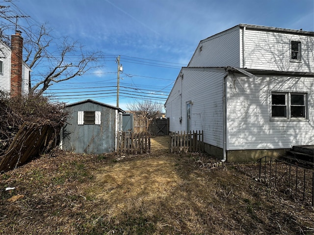 74 Jerusalem Ave, Massapequa, NY 11758 - view of home's exterior featuring a shed, an outdoor structure, and fence