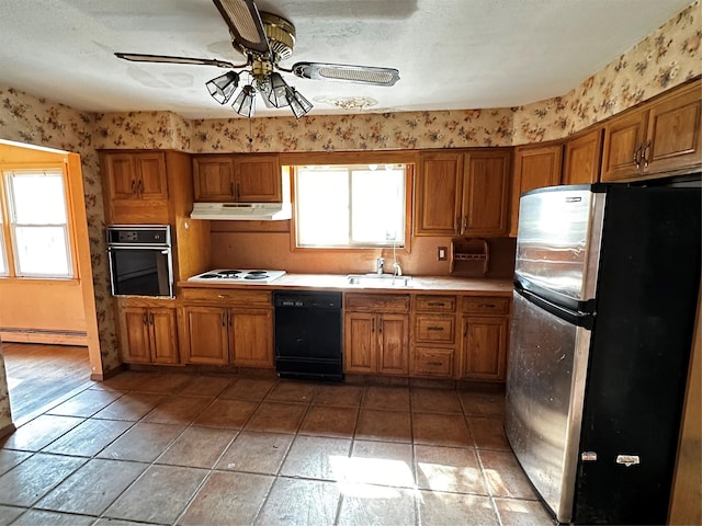 74 Jerusalem Ave, Massapequa, NY 11758 - kitchen with a baseboard radiator, black appliances, a sink, and brown cabinetry