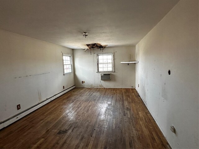 74 Jerusalem Ave, Massapequa, NY 11758 - empty room with a wall mounted air conditioner, a baseboard heating unit, and wood finished floors