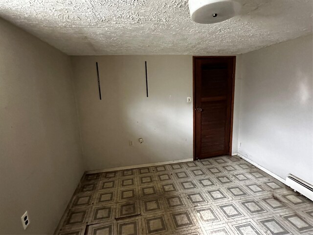 74 Jerusalem Ave, Massapequa, NY 11758 - unfurnished room featuring baseboards, a textured ceiling, and baseboard heating