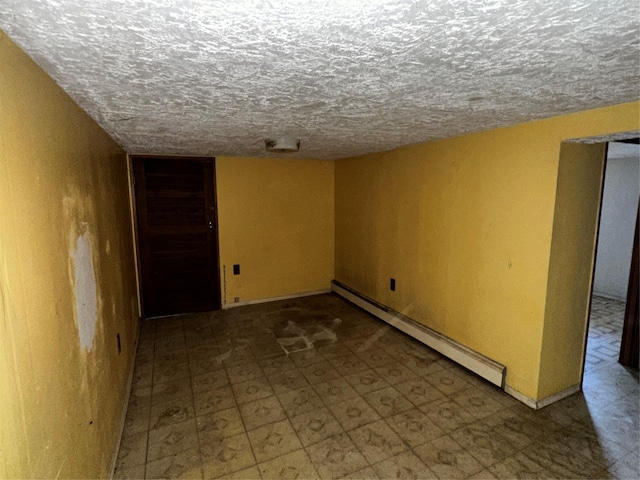 74 Jerusalem Ave, Massapequa, NY 11758 - finished basement with tile patterned floors, a baseboard heating unit, and a textured ceiling