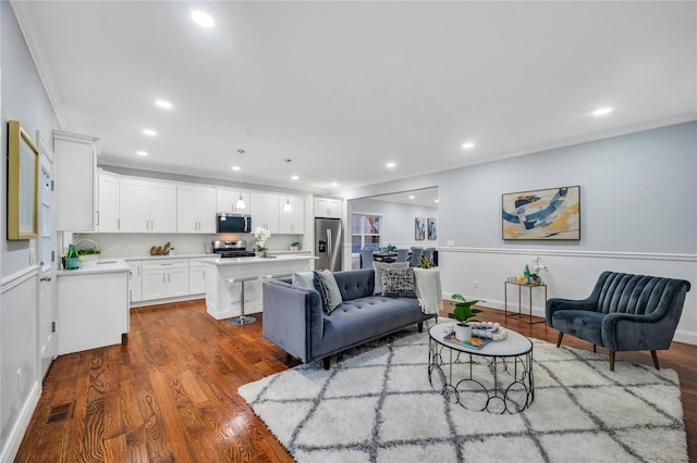 living room with crown molding, recessed lighting, baseboards, dark wood finished floors, and visible vents