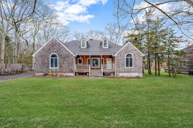 64 Turtle Cove Dr, Southampton, NY 11968 - view of front of property featuring a shingled roof, fence, a front lawn, and a porch