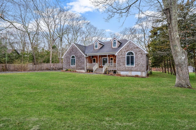 64 Turtle Cove Dr, Southampton, NY 11968 - view of front of house featuring covered porch, a front yard, fence, and roof with shingles
