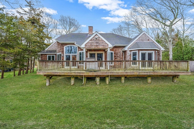 64 Turtle Cove Dr, Southampton, NY 11968 - rear view of house featuring a wooden deck, a shingled roof, a yard, and a chimney