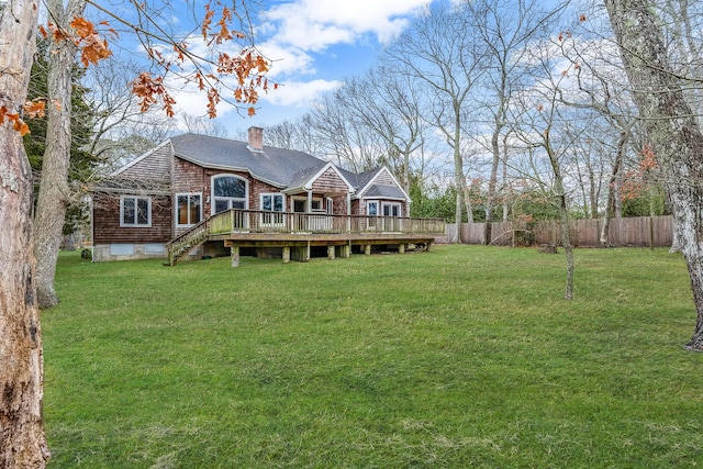 64 Turtle Cove Dr, Southampton, NY 11968 - rear view of property with fence, a lawn, a wooden deck, a shingled roof, and a chimney