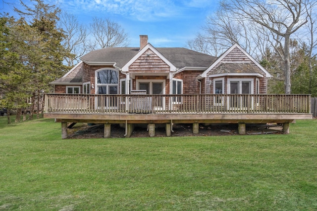 64 Turtle Cove Dr, Southampton, NY 11968 - rear view of property featuring a lawn, a chimney, a shingled roof, and a wooden deck