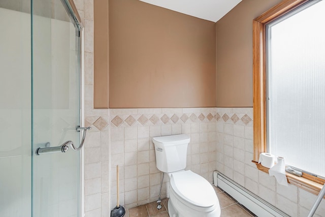 64 Turtle Cove Dr, Southampton, NY 11968 - bathroom featuring toilet, a stall shower, tile walls, and baseboard heating