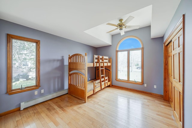 64 Turtle Cove Dr, Southampton, NY 11968 - unfurnished bedroom with wood-type flooring, baseboards, and baseboard heating