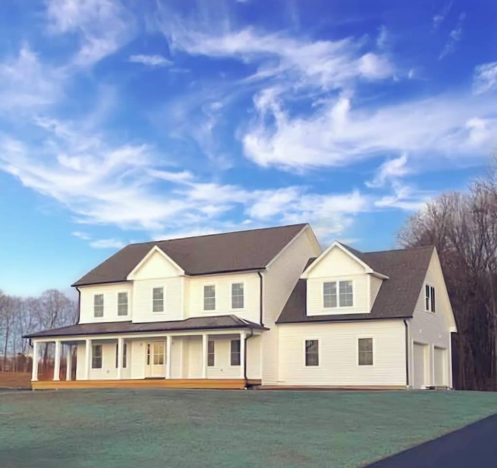 28 Peale Pl, Montgomery, NY 12549 - view of front facade featuring a front lawn, driveway, an attached garage, and a porch