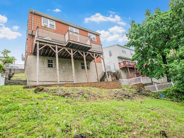 back of property featuring a wooden deck and fence