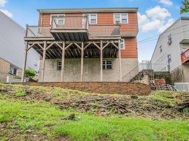rear view of house featuring stairway and a deck