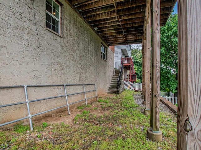 view of yard featuring stairs and fence