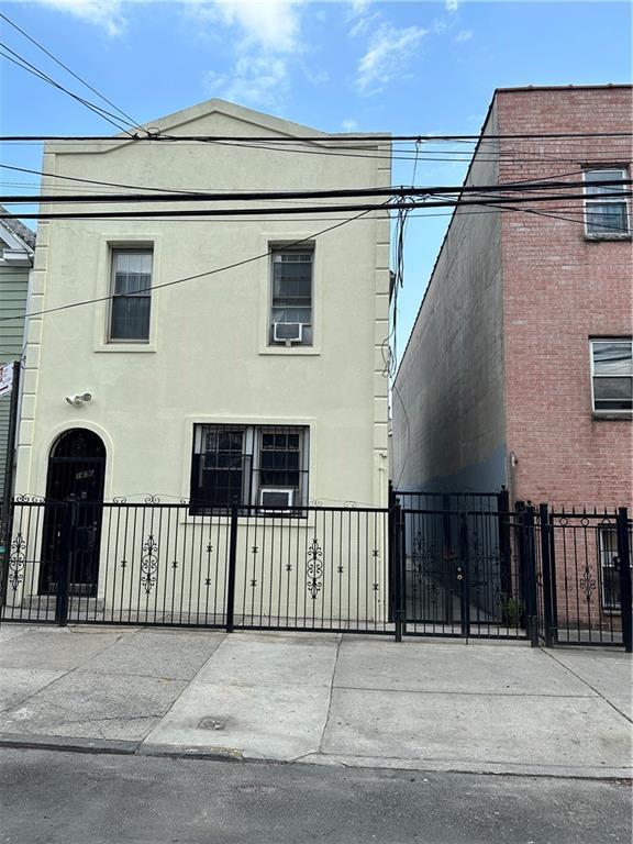 1456 Bryant Ave, Bronx, NY 10460 - exterior space with stucco siding, a gate, and a fenced front yard