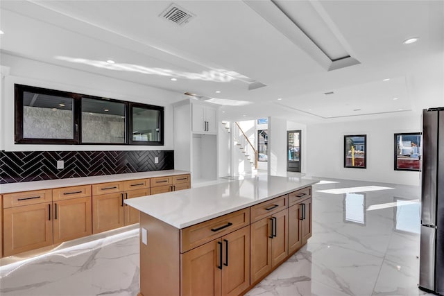 3585 Martha Blvd, Bethpage, NY 11714 - kitchen featuring light countertops, tasteful backsplash, marble finish floor, visible vents, and freestanding refrigerator