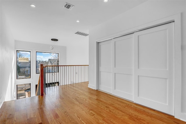 3585 Martha Blvd, Bethpage, NY 11714 - unfurnished room with visible vents, a chandelier, recessed lighting, and light wood-type flooring