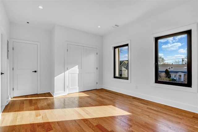 3585 Martha Blvd, Bethpage, NY 11714 - unfurnished bedroom with recessed lighting, visible vents, baseboards, and wood finished floors