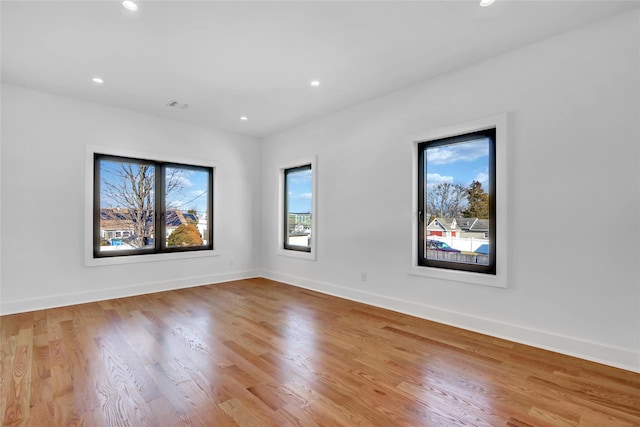 3585 Martha Blvd, Bethpage, NY 11714 - spare room with baseboards, a wealth of natural light, visible vents, and wood finished floors
