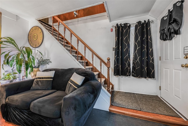 interior space featuring vaulted ceiling and stairs