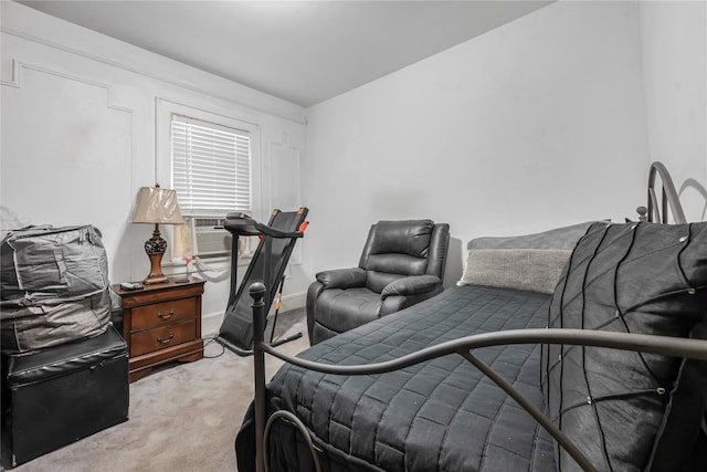 bedroom featuring light carpet, cooling unit, and baseboards