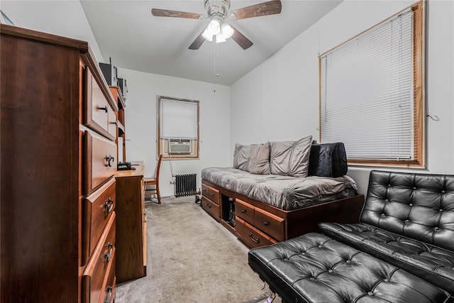 bedroom featuring cooling unit, light carpet, radiator heating unit, and ceiling fan