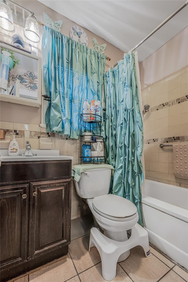 full bathroom featuring vanity, tile patterned flooring, shower / bath combination with curtain, toilet, and tile walls