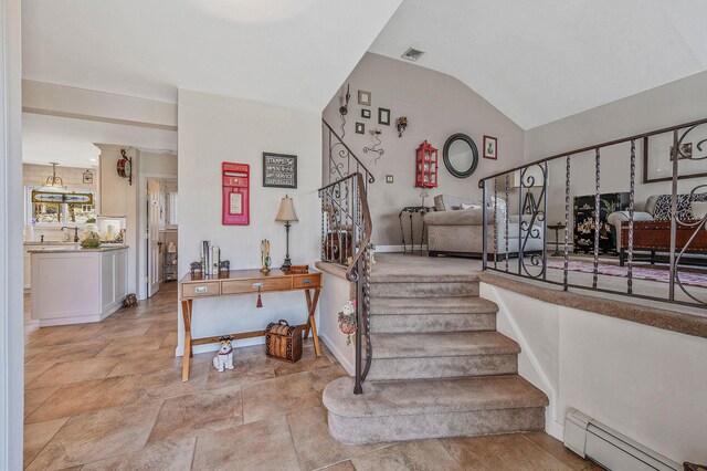 staircase featuring lofted ceiling, stone finish floor, visible vents, baseboards, and baseboard heating
