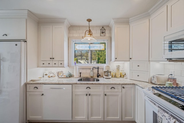 kitchen featuring white cabinets, white appliances, a sink, and backsplash