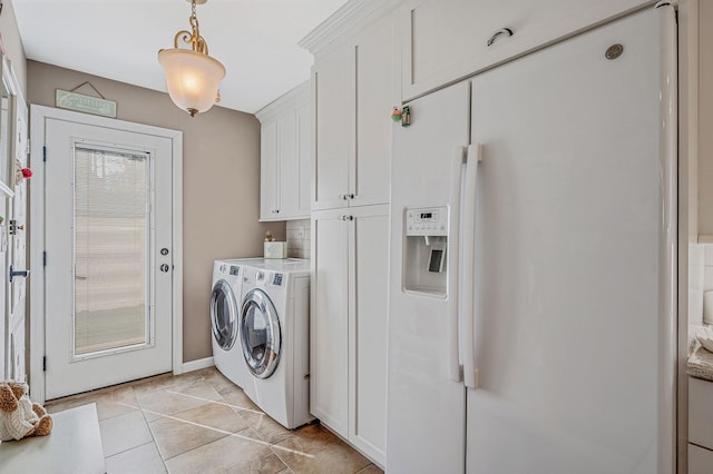 laundry room featuring cabinet space, washing machine and dryer, baseboards, and light tile patterned floors