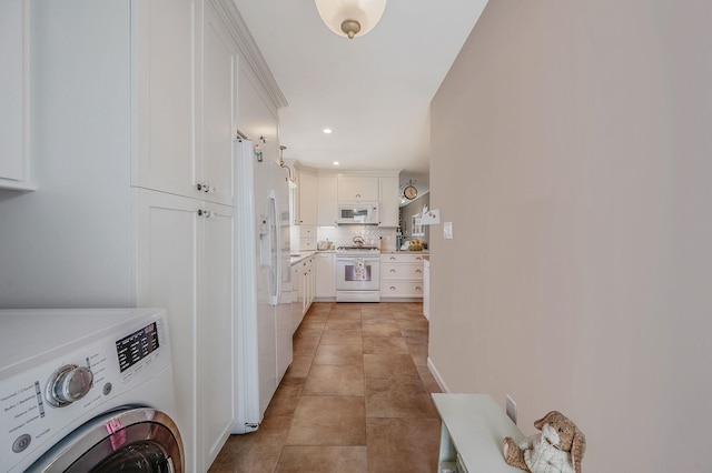 hallway with washer / clothes dryer and recessed lighting