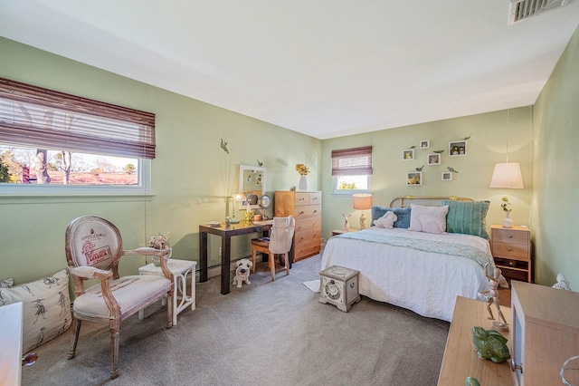 carpeted bedroom featuring visible vents