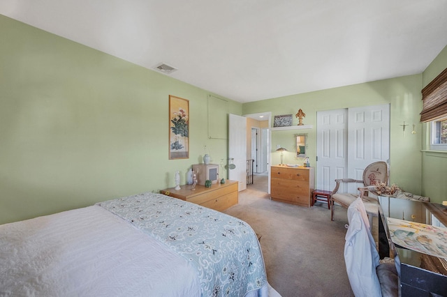 bedroom featuring a closet, carpet, and visible vents