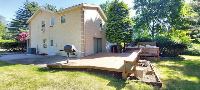 2 N Eckerson Ln, Spring Valley, NY 10977 - rear view of property with stucco siding, a lawn, a deck, and central air condition unit