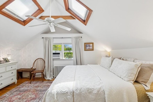 3320 Oregon Rd, Mattituck, NY 11952 - bedroom featuring radiator, wood finished floors, a skylight, and a ceiling fan
