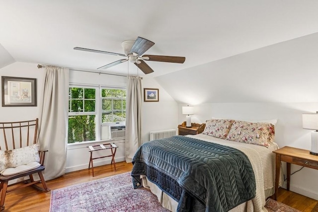 3320 Oregon Rd, Mattituck, NY 11952 - bedroom with radiator, lofted ceiling, cooling unit, wood finished floors, and ceiling fan